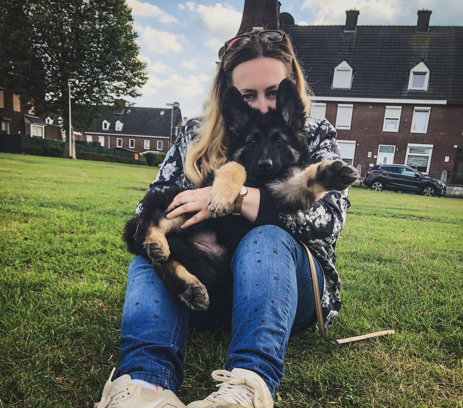 Melissa holding young Arya on the grass